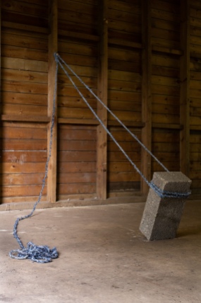 Brace, 2018. Rope made from denim jeans, concrete block.